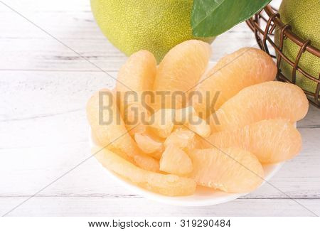Fresh Peeled Pomelo, Grapefruit, Shaddock With Green Leaf On Bright Wooden Plank Table. Seasonal Fru