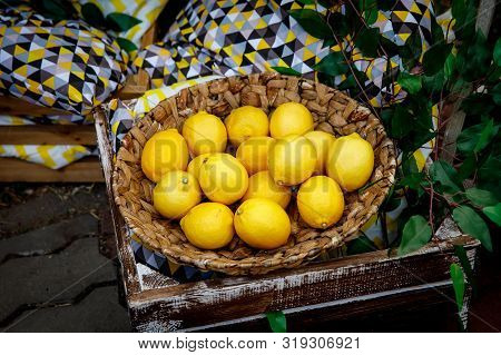 Lemons In A Basket, Green Floral Background.