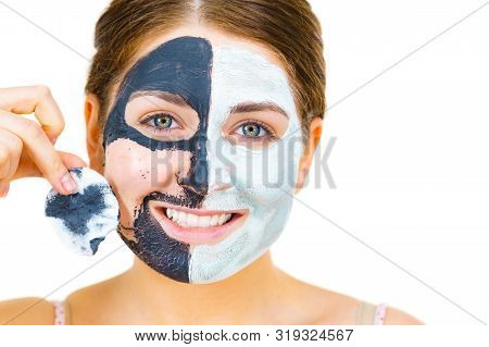 Woman With Clay Carbo Black Mask On One Half Face And White Mud On Second Half. Girl Removing Cosmet