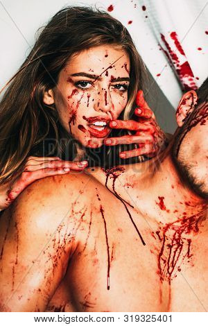 Happy Halloween. Terrifying Zombie Couple. Blood Is Flowing Down The Neck, Bite Marks Are Visible. A