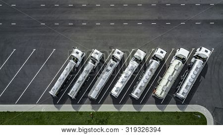 Trucks Stand In A Row In The Parking Lot Top View. Logistics Centre.
