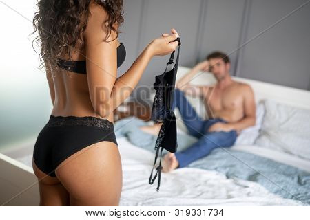 Attractive Sexy Woman With Her Partner In Bedroom
