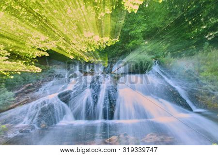 Photo Of The Waterfall, Taken At A Long Shutter Speed With A Change In Focal Length. Abstract Drawin
