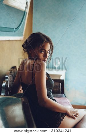 Beautiful Young Woman Mixed Race In Seductive Lingerie Sitting On Vintage Sofa. Boudoir Portrait Of 