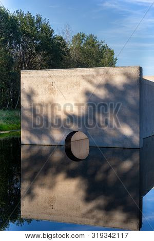 Waterloopbos, The Netherlands, August 25, 2019: The Concrete National Monument, Reflecting In The Su