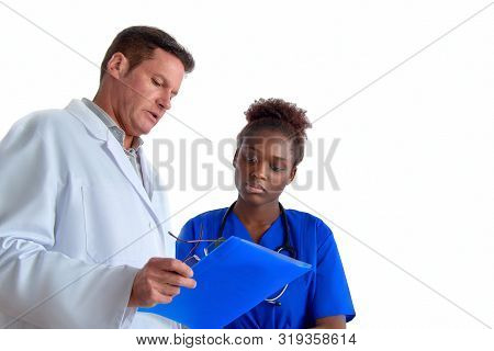Doctor Explains To The Nurse Treatment Pllan For A Patient, Two Professionals, Seinor White Male And