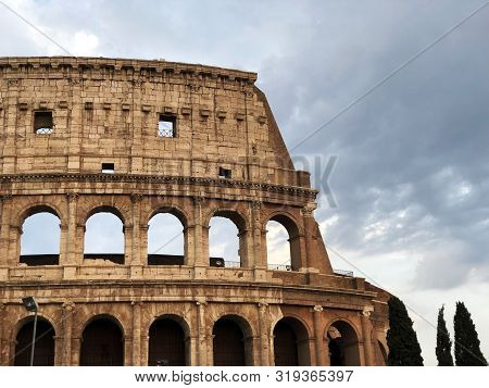 Colosseum In Rome Italy Across Evening Sky And Clouds