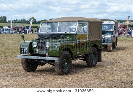 Haselbury Plucknett.somerset.united Kingdom.august 18th 2019.a Vintage Land Rover Is Being Driven At