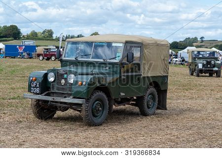 Haselbury Plucknett.somerset.united Kingdom.august 18th 2019.a Vintage Land Rover Is Being Driven At