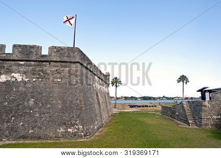 Castillo De San Marcos Fort And Field, With Cannons, Palm Trees And A Blue Sky. Saint Augustine, Flo