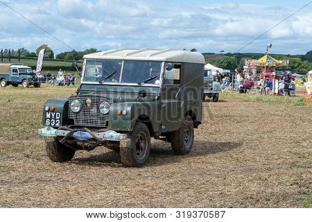 Haselbury Plucknett.somerset.united Kingdom.august 18th 2019.a Vintage Land Rover Is Being Driven At