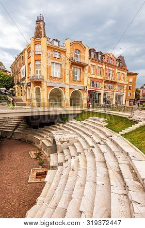 Plovdiv, Bulgaria - 22 June 2019: Ancient Roman Stadium In The Center Of Plovdiv And Building In Bac