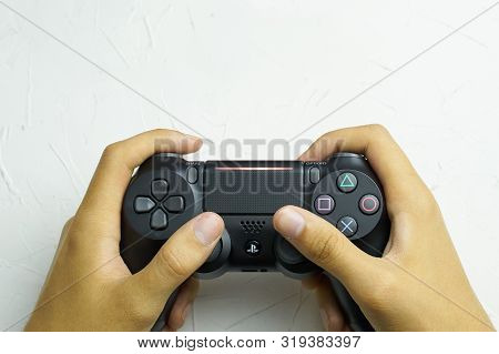 Bishkek, Kyrgyzstan - June 06, 2019: The New Sony Dualshock Black Color Front View On The Hand