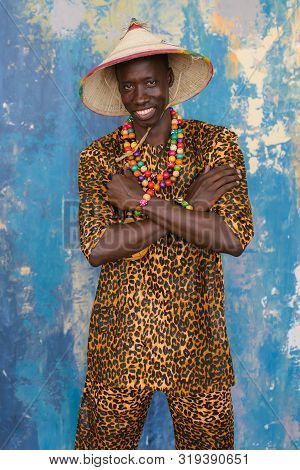 Handsome African Men In Traditional Fulani Hats And Colorful Posing At Studio