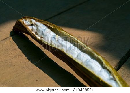 A Few Ice Cream Bean (pacay Fruit) On Wood Terrace.