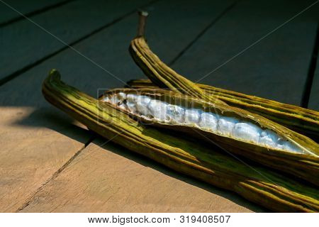 A Few Ice Cream Bean (pacay Fruit) On Wood Terrace.