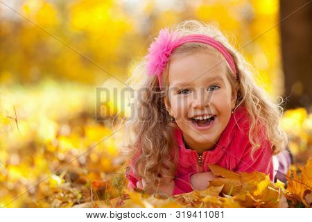 Happy little child in autumn park