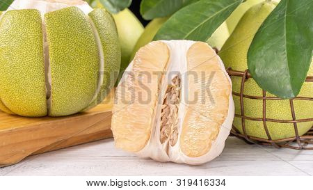 Fresh Peeled Pomelo, Grapefruit, Shaddock With Green Leaf On Bright Wooden Plank Table. Seasonal Fru