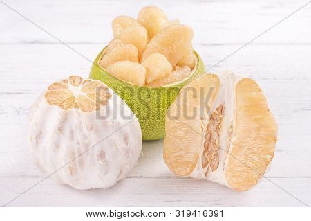 Fresh Peeled Pomelo, Grapefruit, Shaddock With Green Leaf On Bright Wooden Plank Table. Seasonal Fru