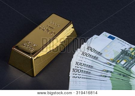 Euro Cash And Gold Bar On A Black Background. Banknotes. Money. Bill. Ingot. Bullion.