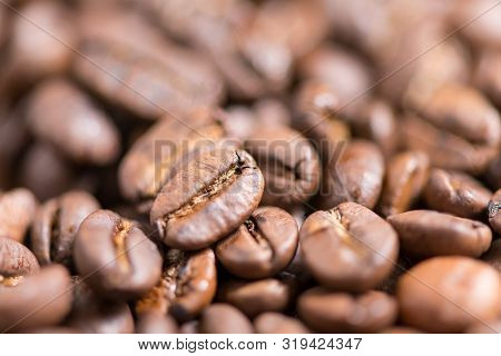 Coffee Beans On A Plate Placed On A Wooden Table.