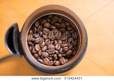 Coffee Beans Are Ground Into Coffee Powder By A Grinder