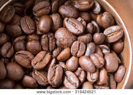 Coffee Beans Are Ground Into Coffee Powder By A Grinder