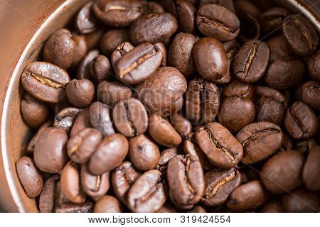 Coffee Beans Are Ground Into Coffee Powder By A Grinder