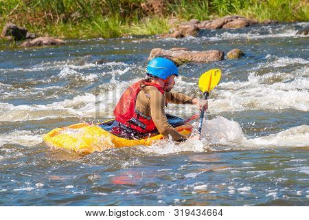 Myhiya, Ukraine - August 17, 2019: Playboating. A Man Sitting In A Kayak With Oars In His Hands Perf