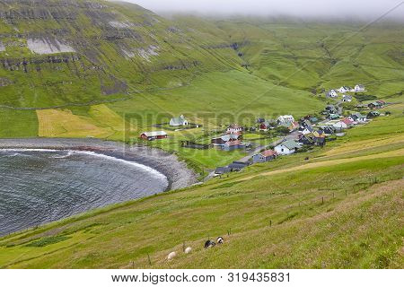 Traditional Faroe Village Of Dalur In Sandoy Island. Cloudy Day