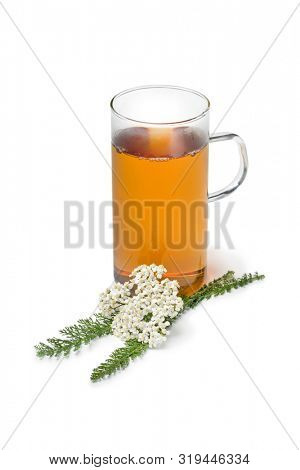 Fresh Common yarrow flowers and a cup of tea isolated on white background