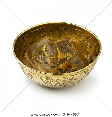 Savon beldi in a decorated metal cup isolated on white background