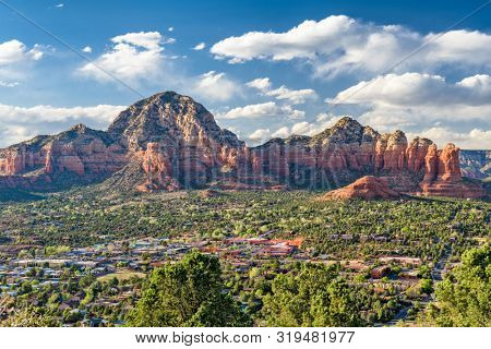 Sedona, Arizona, USA downtown skyline below the red rock mountains.