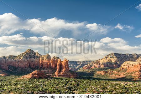Sedona, Arizona, USA downtown skyline below the red rock mountains.