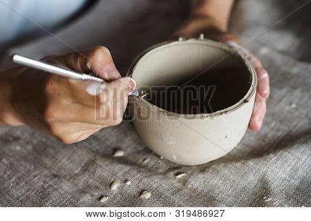 Female Hands Hold A Bowl For Casting Clay Products