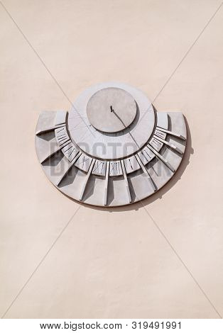 Old Solar Clock On A White Wall, Close Up. Old Fashioned Sun Dial On A Stone Wall Isolated On White,