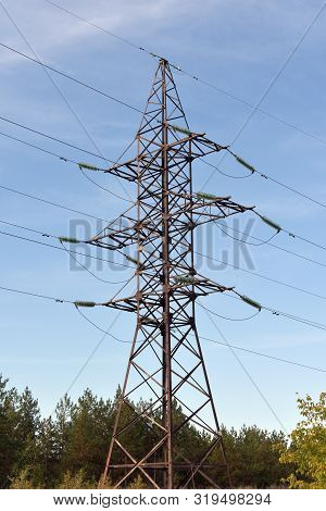 High Voltage Tower Against The Blue Sky. Electric Tower And Cables. Electrical Linear Insulator. Ver