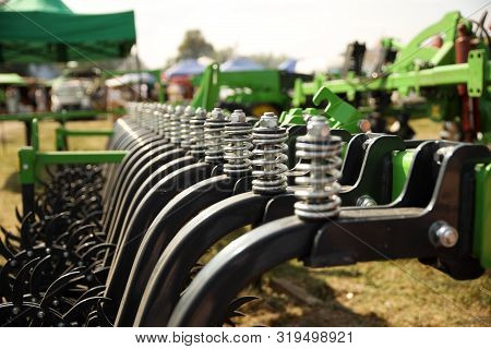Spring Shock Absorbers Cultivator. A Fragment Of Agricultural Machinery For Loosening Plowed Fields.