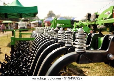 Spring Shock Absorbers Cultivator. A Fragment Of Agricultural Machinery For Loosening Plowed Fields.