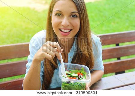 Attractive Young Business Woman Have A Lunch Sitting In City Park Looking At Camera.