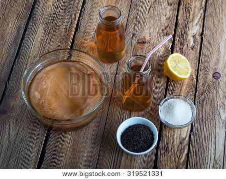 Kombucha By Fermenting Tea With Symbiotic Culture Of Bacteria And Yeast On Wooden Table.