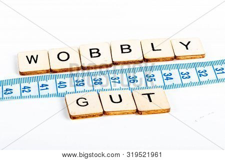 Health Concept Of A Tape Measure Also Showing The Message Wobbly Gut