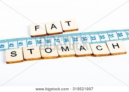 Health Concept Of A Tape Measure Also Showing The Message Fat Stomach