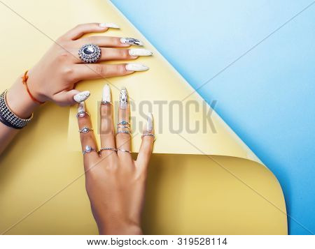 Woman Hands Holding Colorful Paper Copyspace Wearing A Lot Of Jewelry And Long Nails Closeup