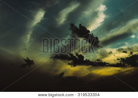 Evening Sky At Sunset Background. Dark Clouds Hanging Above Horizon. Majestic Cloudscape In Blue, Or