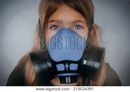 Young Girl Wearing Gasmask, Respirator Portrait. Effects Of Worldwide Air Pollution, Industrial Infl