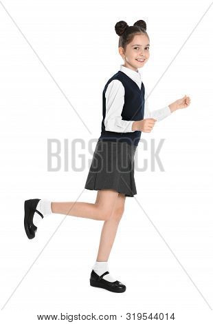 Happy Girl In School Uniform Walking On White Background