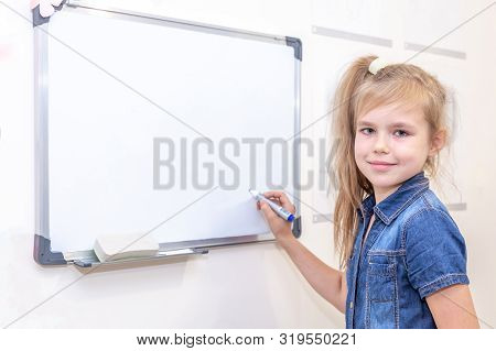 Pipil Girl Standing Near White Board. Learning And School Concept