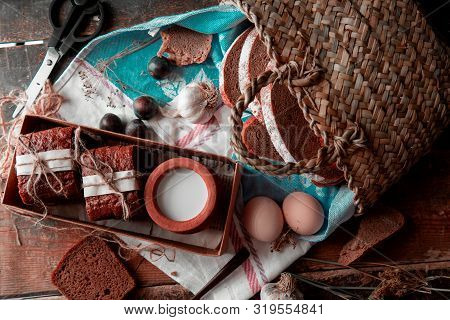 Bread Slices Wrapped With White Paper And Thread, Milk Pot Inside A Boc, Basket Around. Image