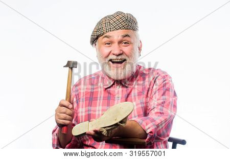 Retro Man Repair Shoes With Hammer. Mature Shoemaker In Workshop Make Shoes. Shoemaker Working With 
